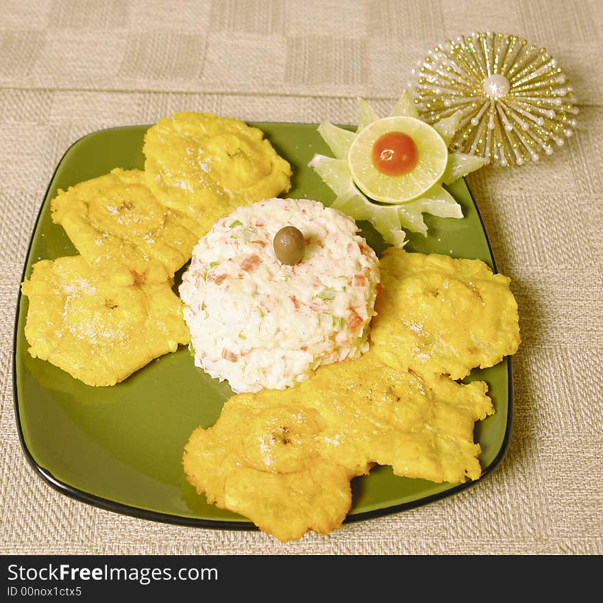 Crabmeat imitation salad with fried plantains and christmas decoration. Crabmeat imitation salad with fried plantains and christmas decoration