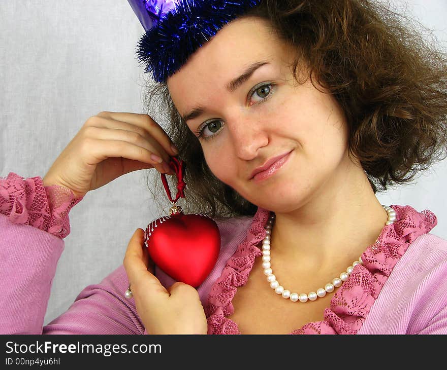 Woman and red heart looking at camera. Woman and red heart looking at camera