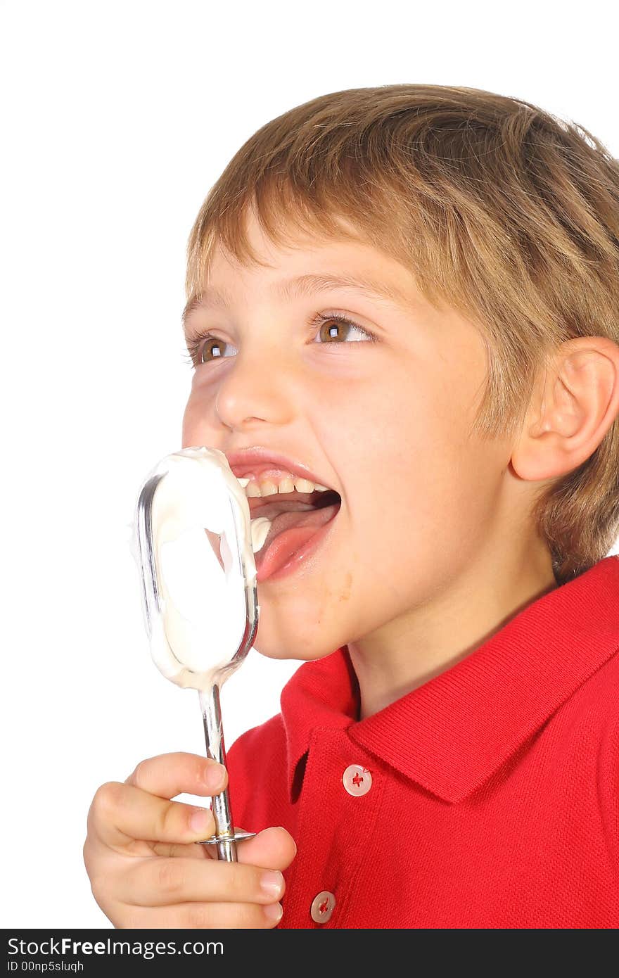 Shot of a happy kid licking frosting