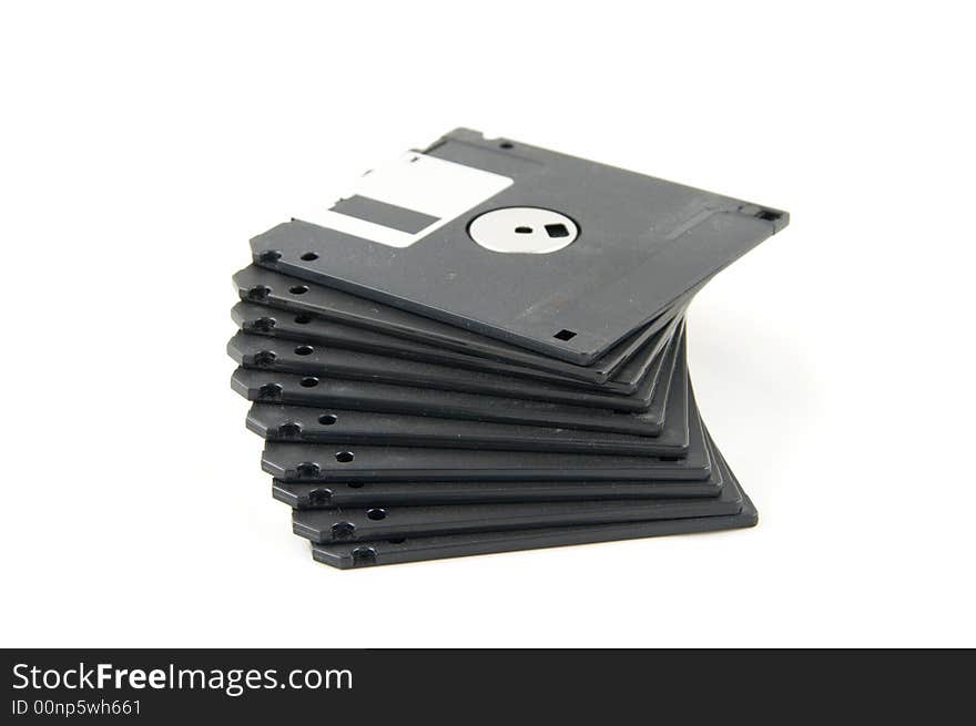 Pile of black diskettes on a white background.