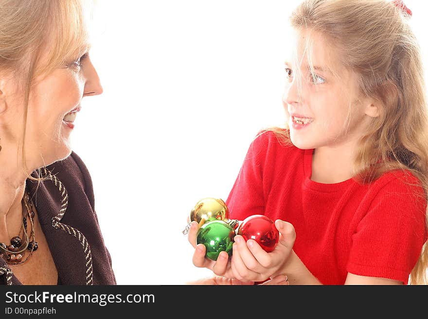 Shot of a child handing woman Christmas ornaments