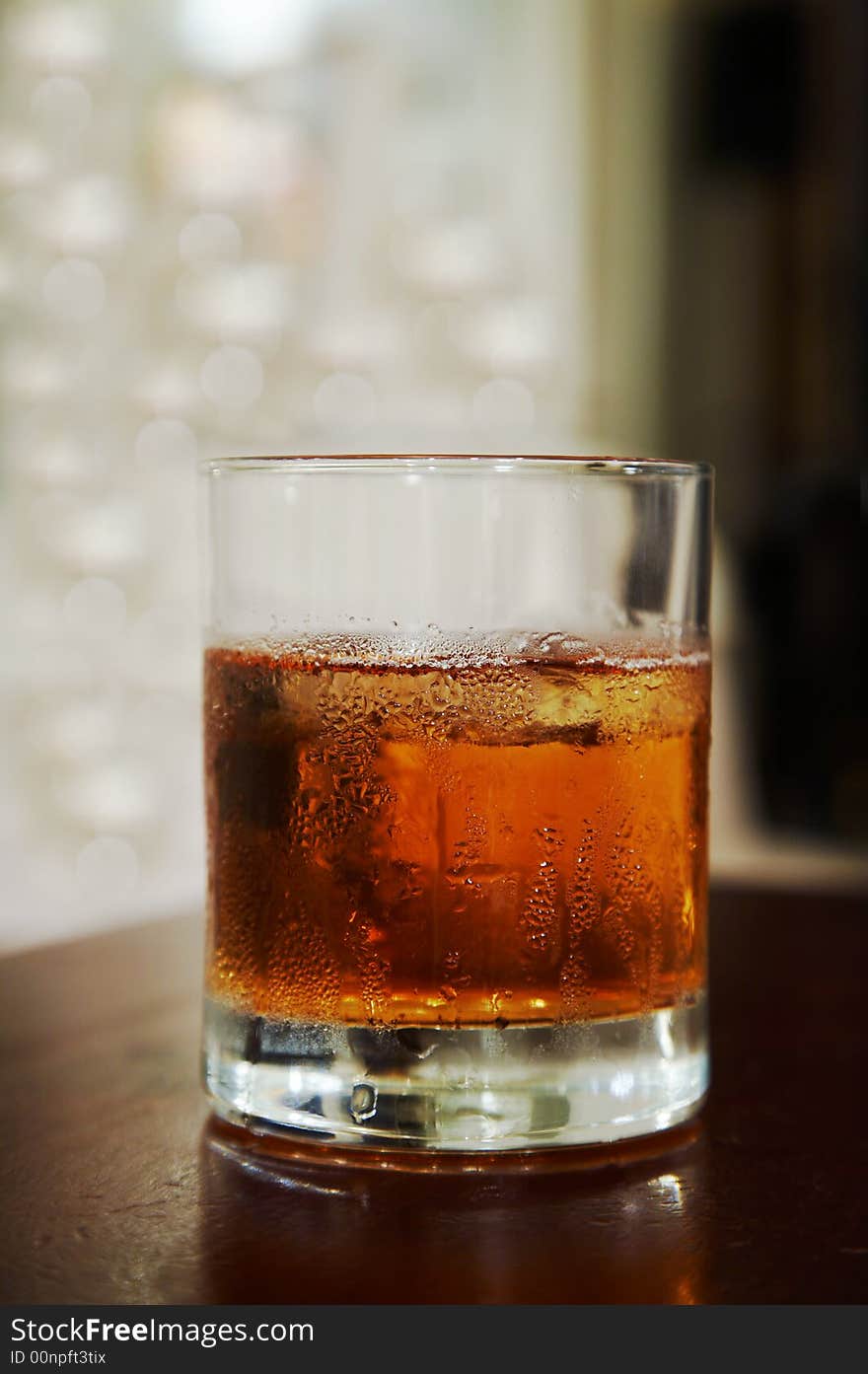 Glass of whisky with an ice