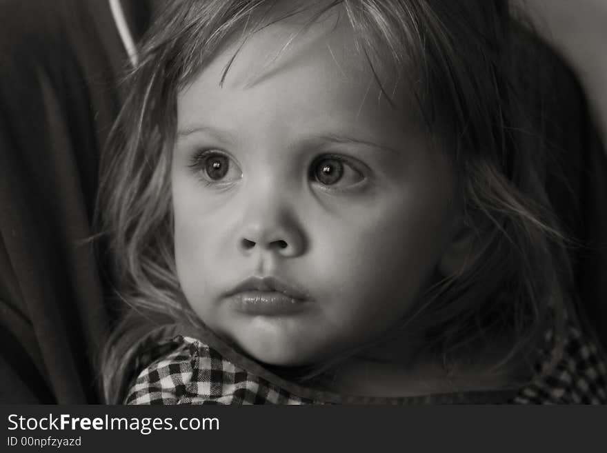 Black-and-white portrait of the girl at mother on hands