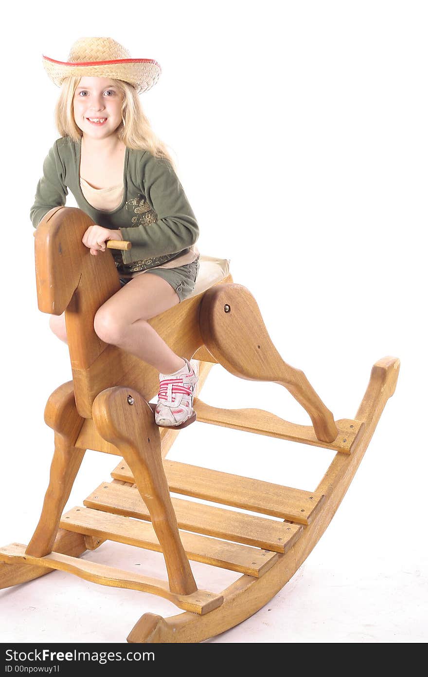 Little girl on rocking horse isolated on a white background