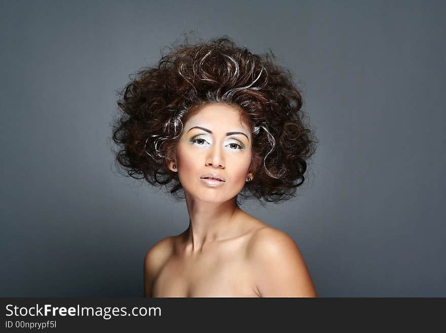 Portrait of a woman in studio against grey background