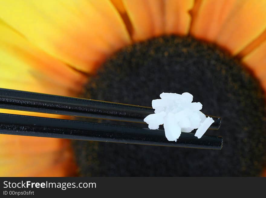 Chopsticks with rice against colorfull background