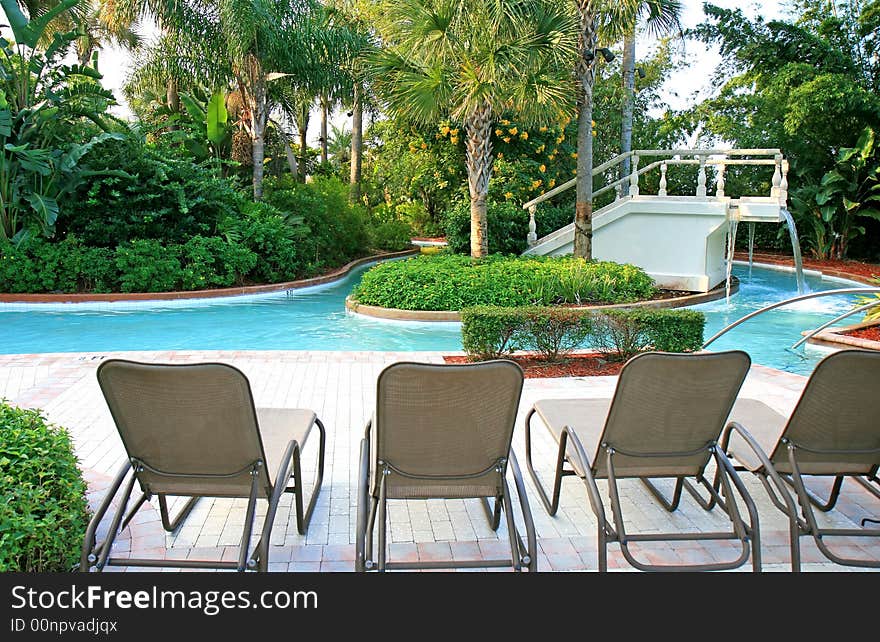 The landscape and swimming pool in a tropical resort. The landscape and swimming pool in a tropical resort