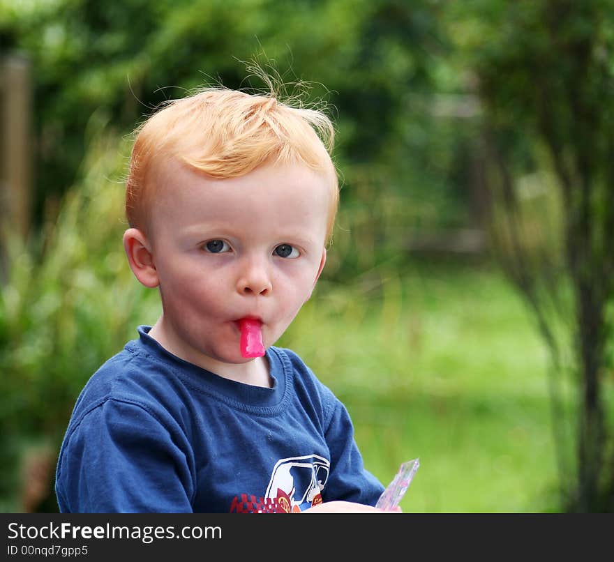 Little lad enjoying his ice lolly. Little lad enjoying his ice lolly