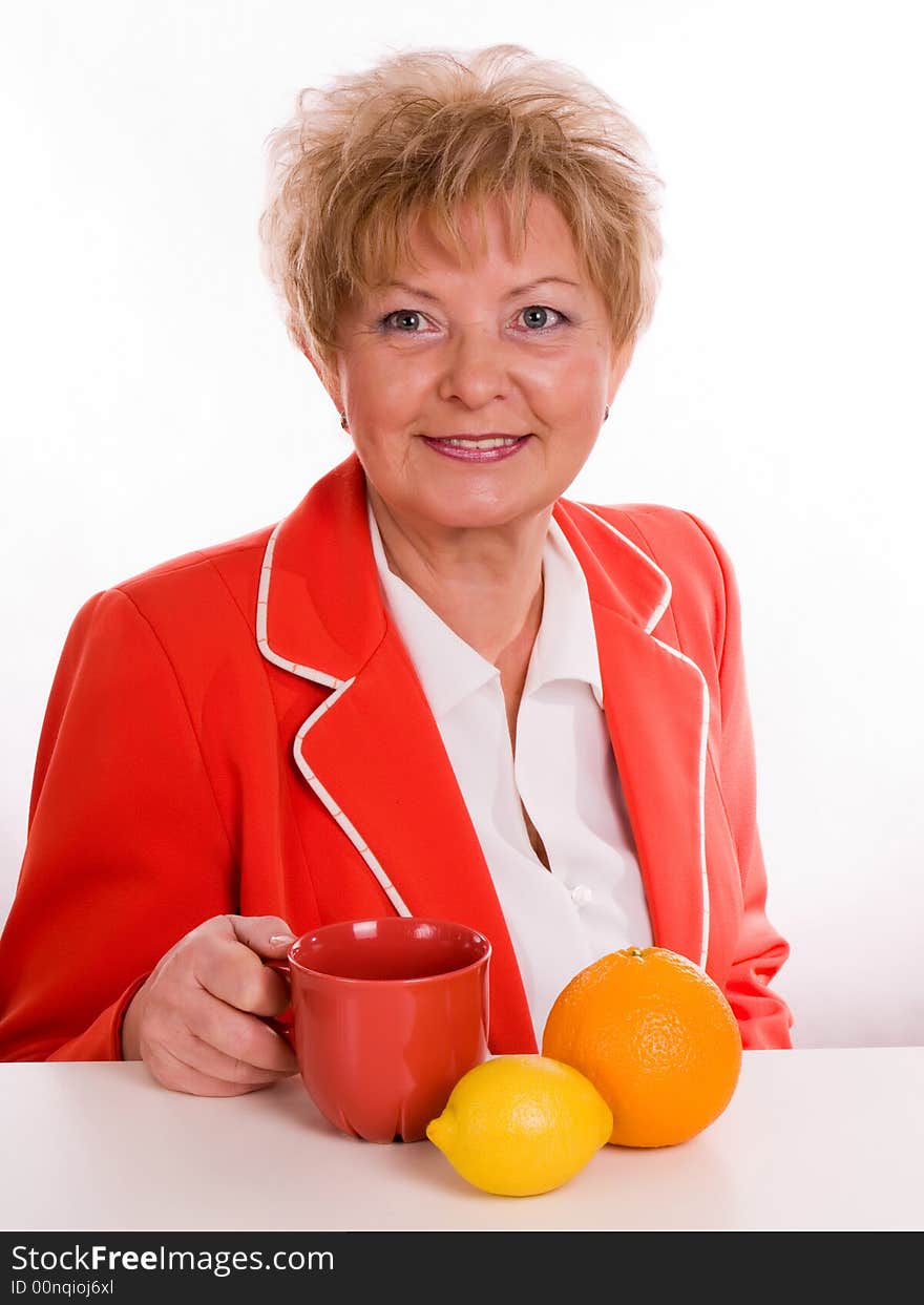 Blond woman with orange and hot beverage. Blond woman with orange and hot beverage