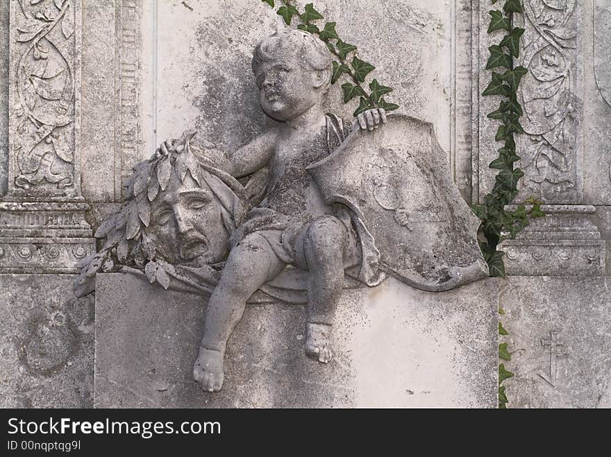 Statue in front of a grave