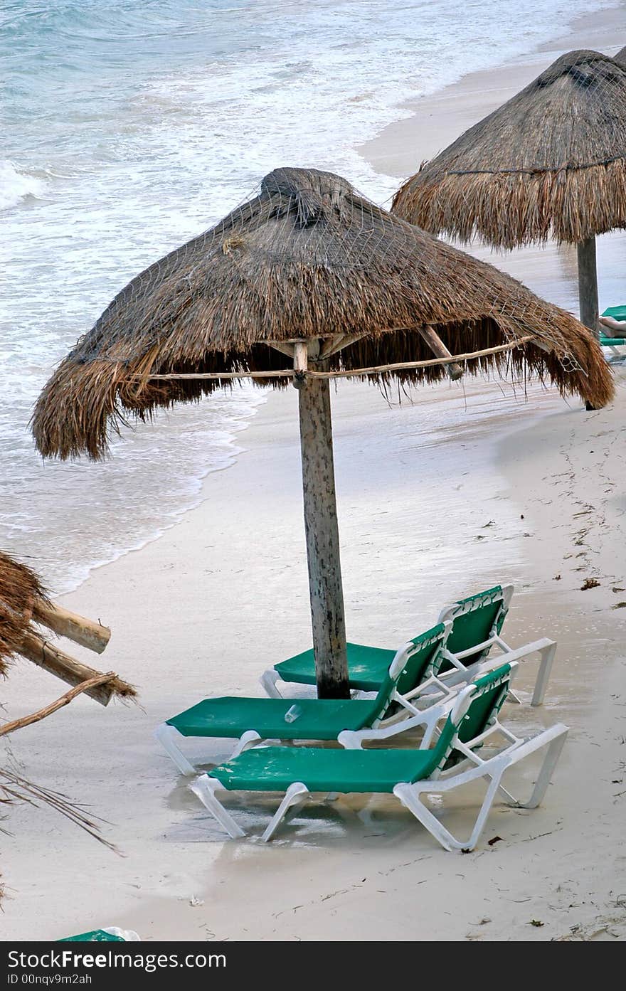 Green chairs and umbrella early in the morning in the beach. Green chairs and umbrella early in the morning in the beach