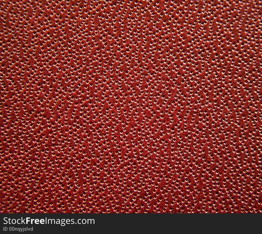 Macro background showing air holes in leather