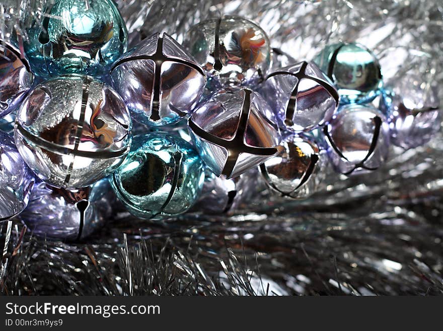 Jingle bells and tinsel for Christmas background.