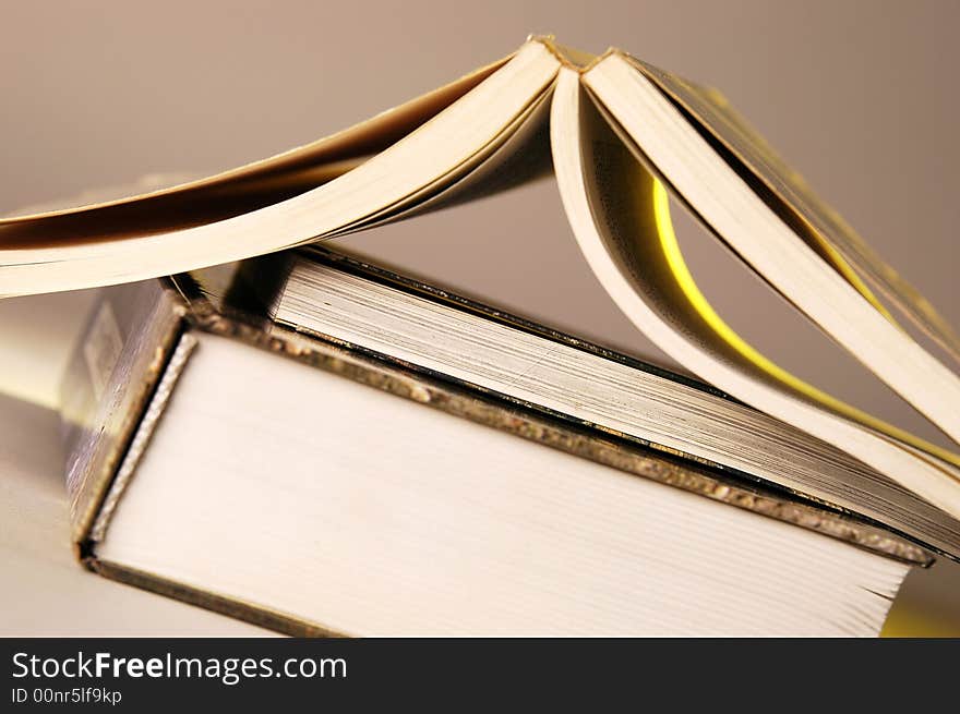 Photo of open books lying on the desk