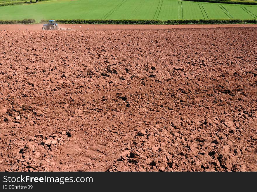 Tractor ploughing the land ready for seeding