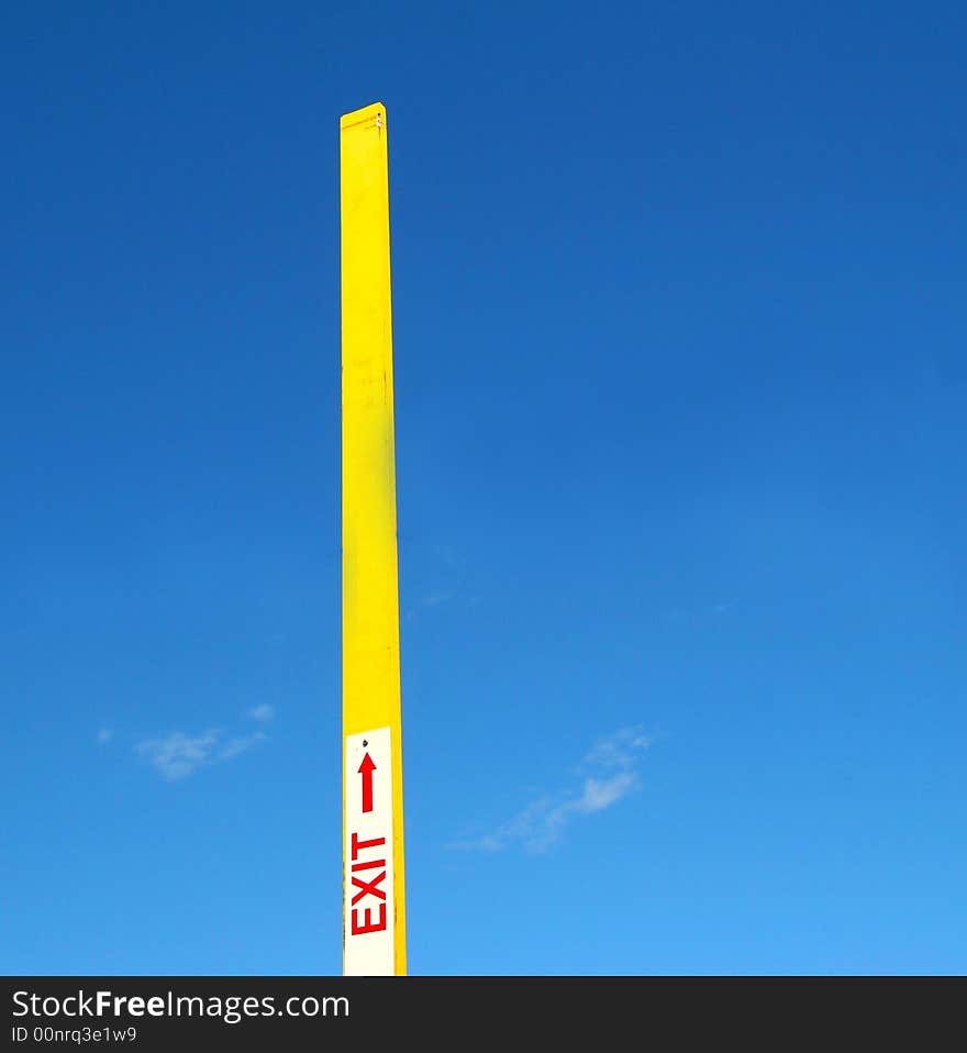 Exit sign on a boomgate pointing towards the sky. Exit sign on a boomgate pointing towards the sky