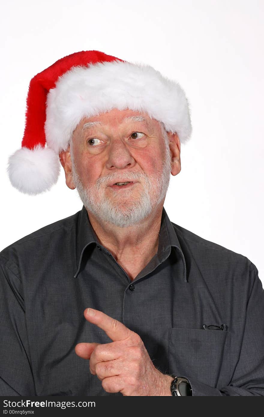 Mature man with white beard and Santa hat waving his finger. Mature man with white beard and Santa hat waving his finger