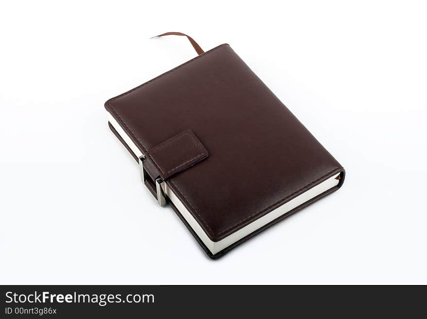 A brown leather diary with a metal buckle and a ribbon bookmark