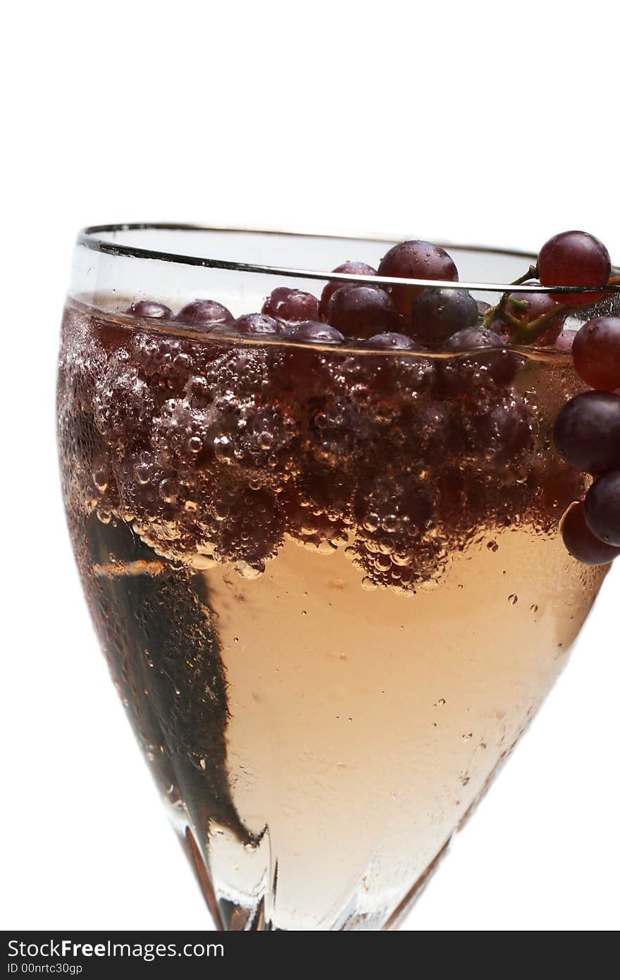 Champagne grapes in a glass of bubbly liquid. Champagne grapes in a glass of bubbly liquid