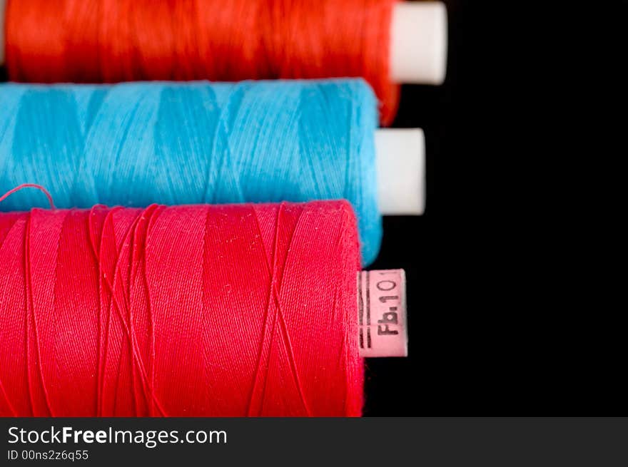 Spools of colorful thread in a row. Spools of colorful thread in a row