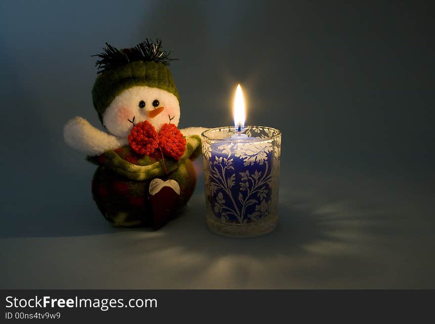 Snowman in candlelight