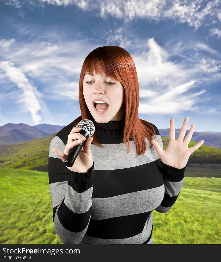 Happy beautiful redhead girl singing on a microphone, karaoke. Studio shot. Happy beautiful redhead girl singing on a microphone, karaoke. Studio shot.