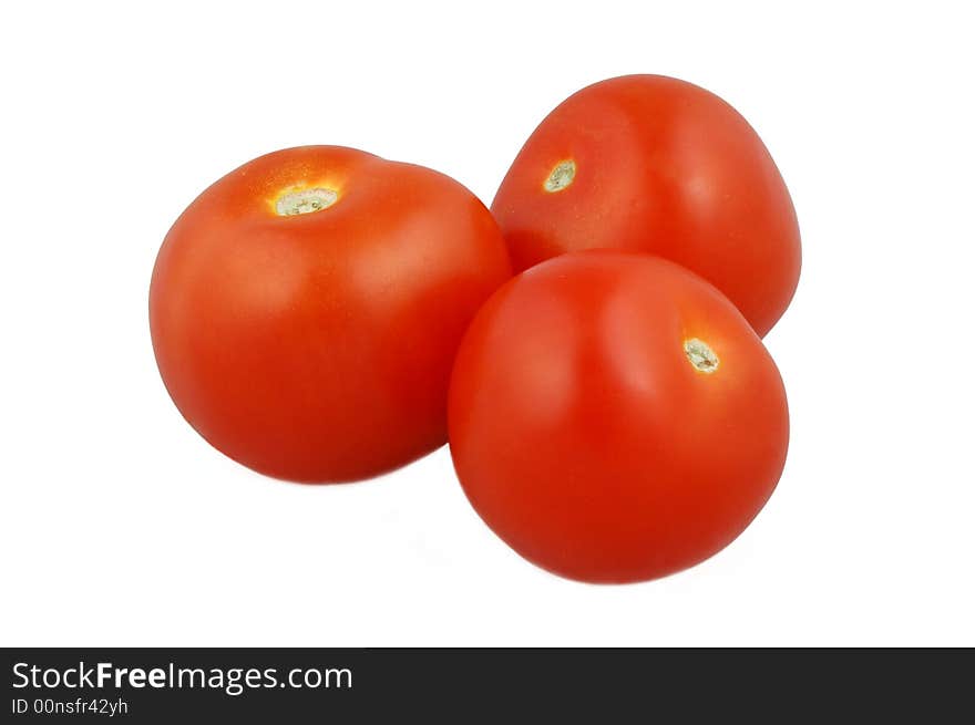 Three juicy red tomatoes isolated on white