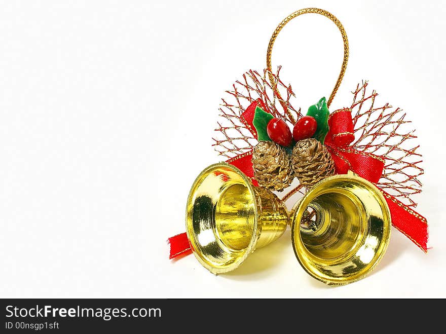 Isolated golden bells with red ribbon and bow against white background. Isolated golden bells with red ribbon and bow against white background