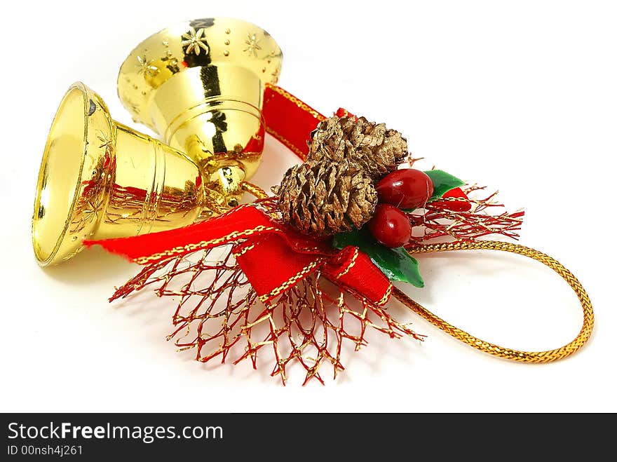 Isolated golden bells with red ribbon against white