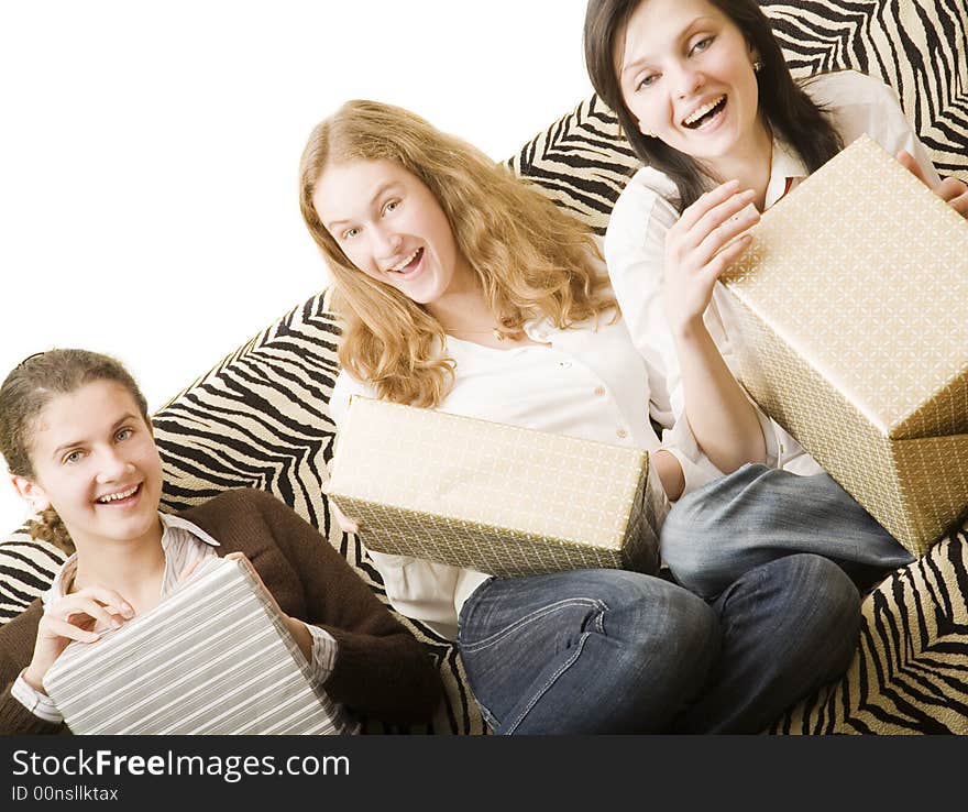 Three girls on the sofa with gifts. Three girls on the sofa with gifts