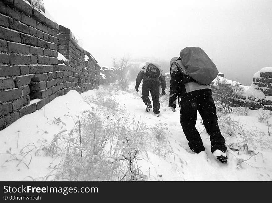 Hikers on The great wall of China after snowfall.Beijing,China.Black and White photo.