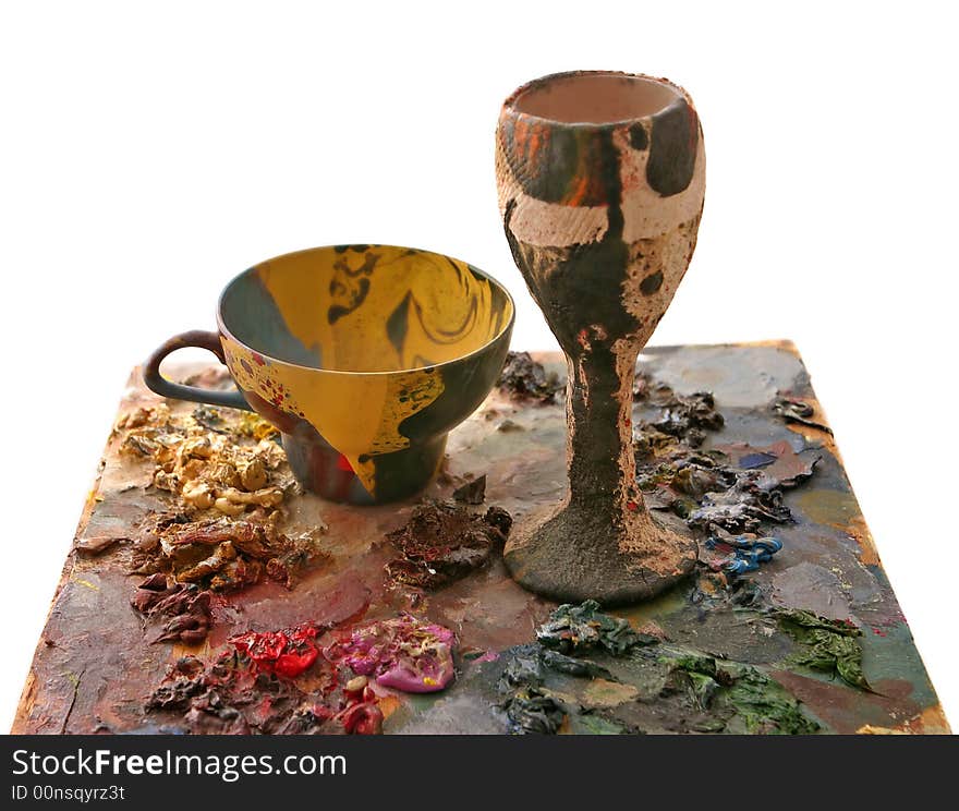 Coloured bowl from papier-mache and cup on oil-paint background