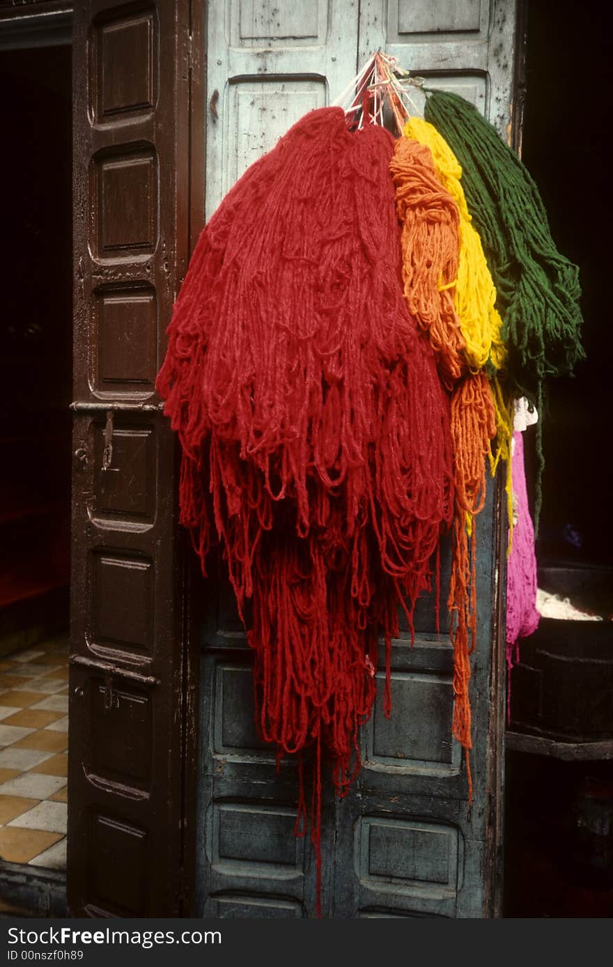 Fresh dyed wool hung out in street to dry. Fresh dyed wool hung out in street to dry