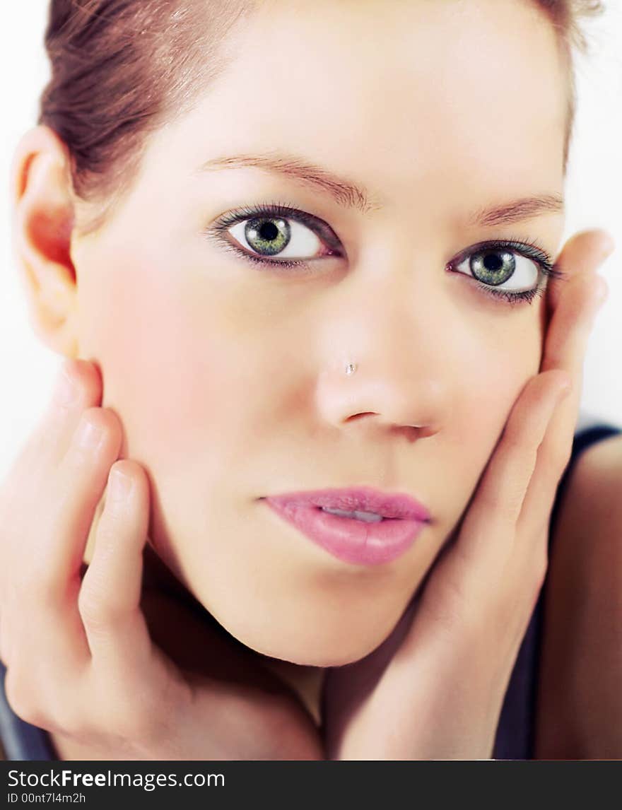 Beautiful young woman holding her face with hands