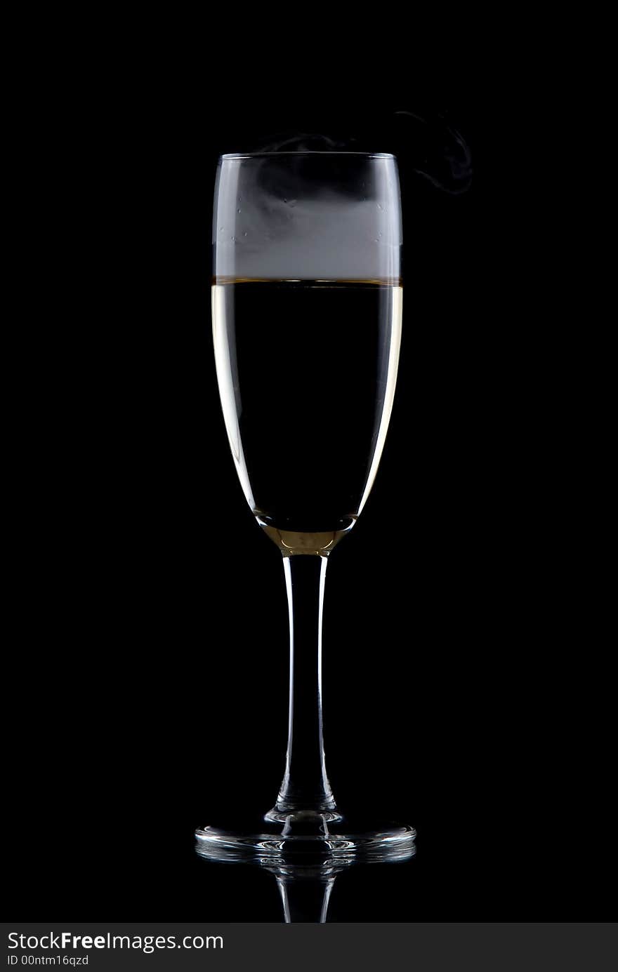 Glass of white wine isolated over black background, with smoke. Glass of white wine isolated over black background, with smoke