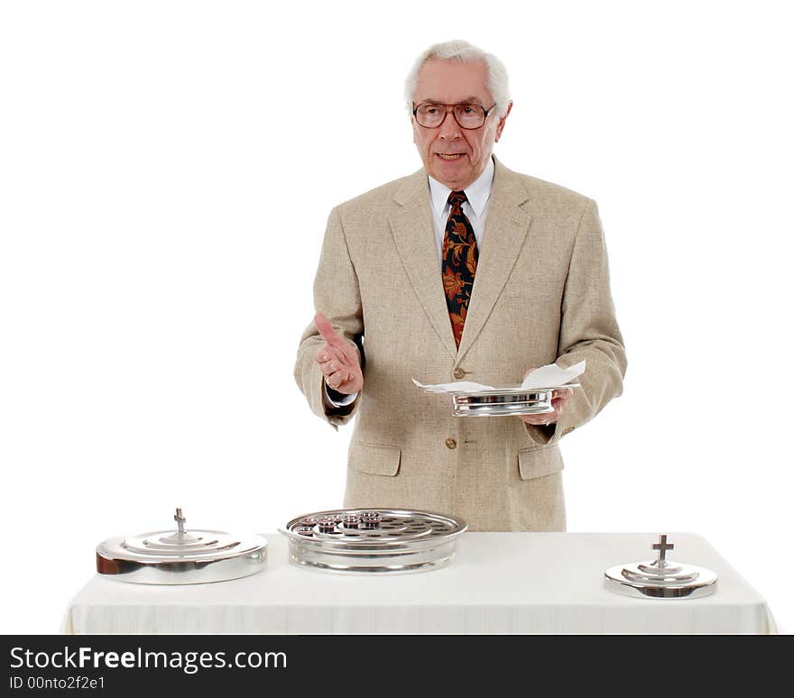 Senior man speading as he hold the tray of bread at the communion table.. Isolated on white. Senior man speading as he hold the tray of bread at the communion table.. Isolated on white.