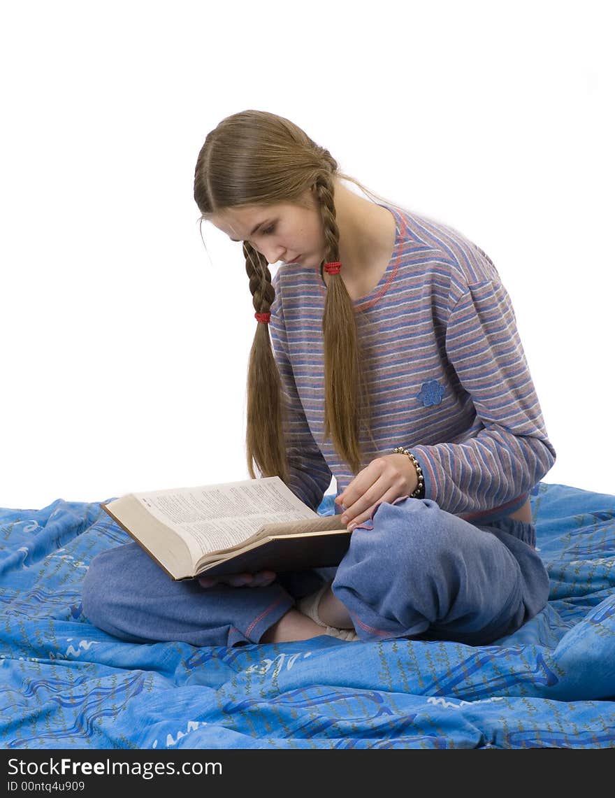 Girl in the home   clothes, reading in bed. Girl in the home   clothes, reading in bed