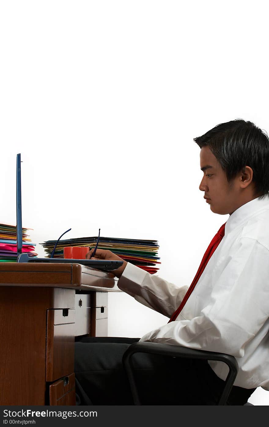 A man working on his laptop over a white background. A man working on his laptop over a white background