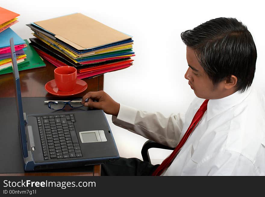 A man working on his laptop over a white background. A man working on his laptop over a white background