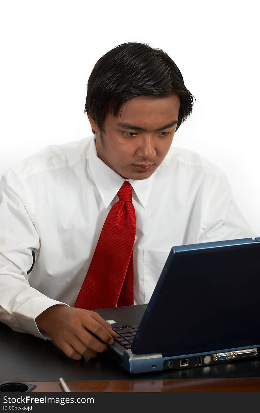 A man working on his laptop over a white background. A man working on his laptop over a white background