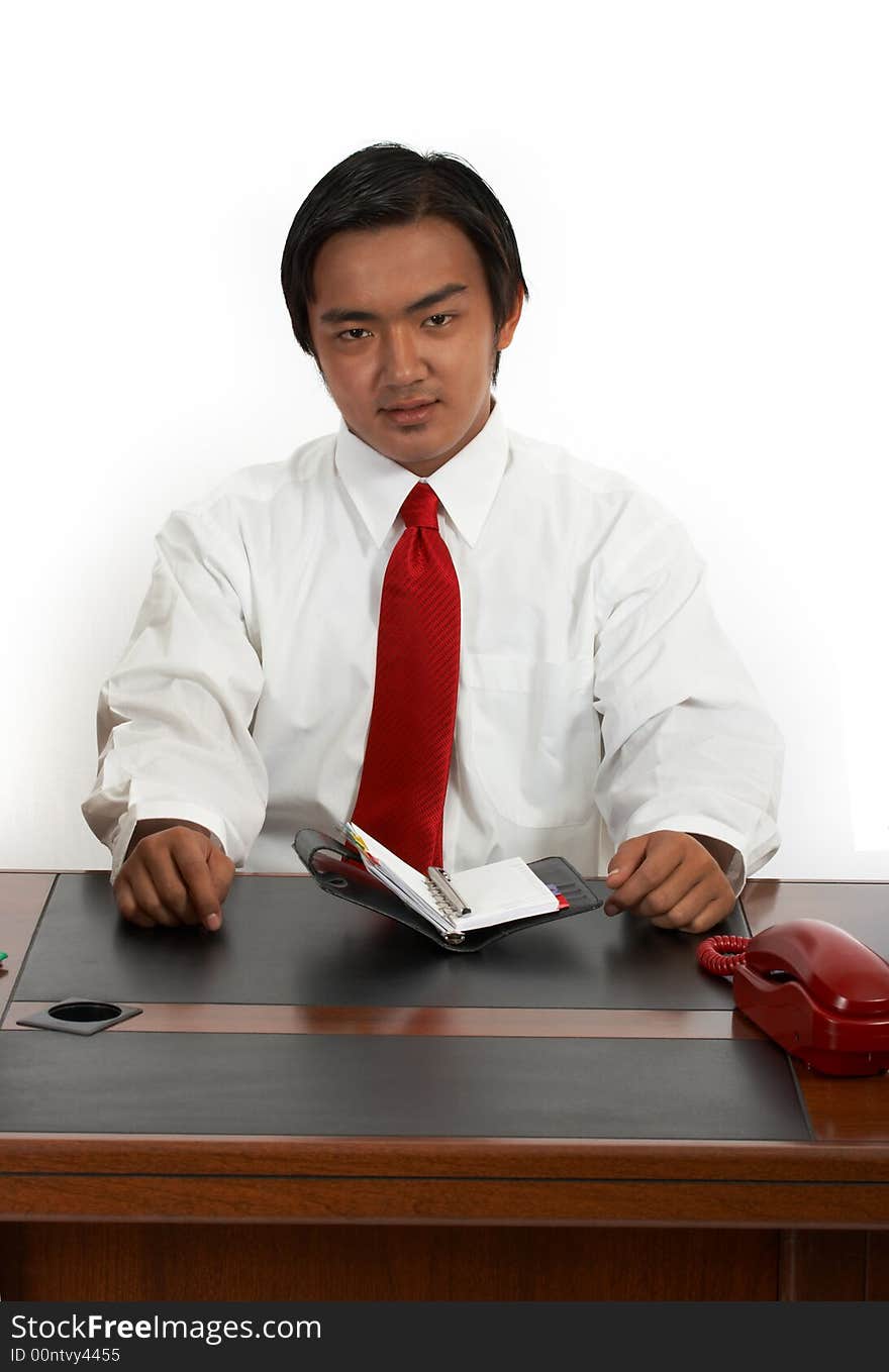 A man sitting behind an office desk. A man sitting behind an office desk