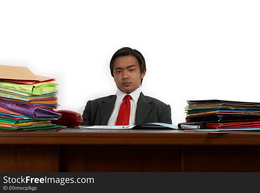 A man sitting behind his office desk. A man sitting behind his office desk