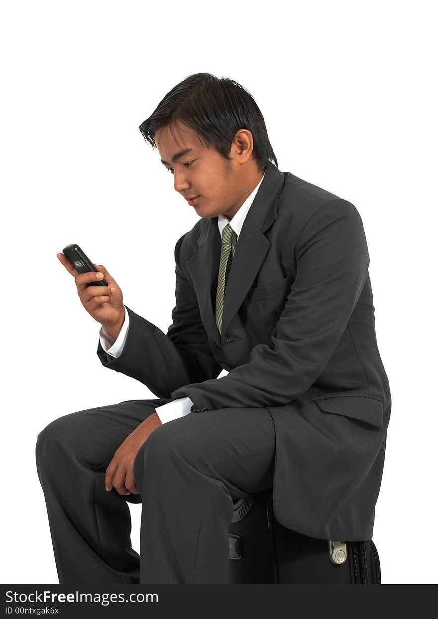 A man sitting on his luggage over a white background. A man sitting on his luggage over a white background