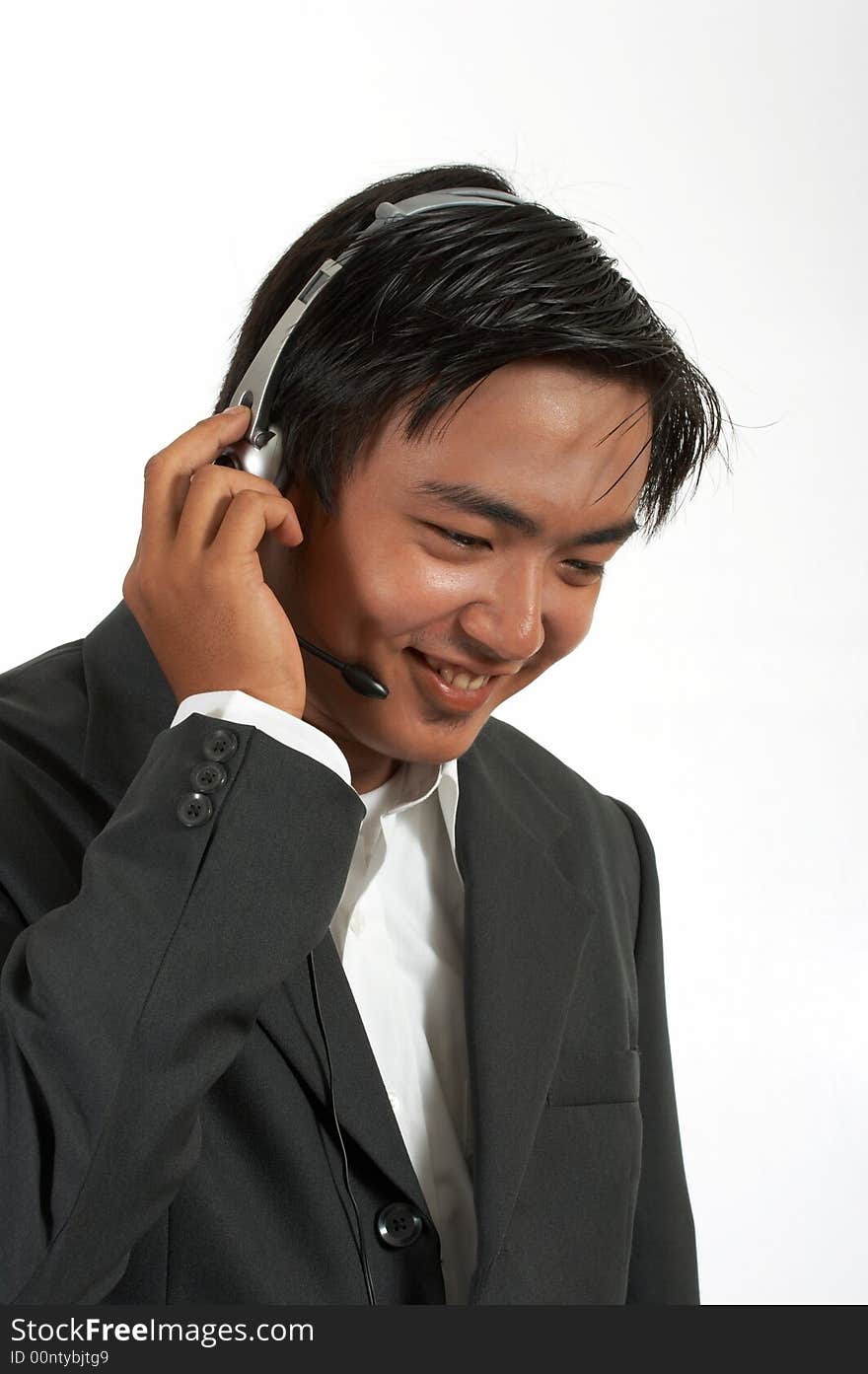 A man wearing a headset over a white background