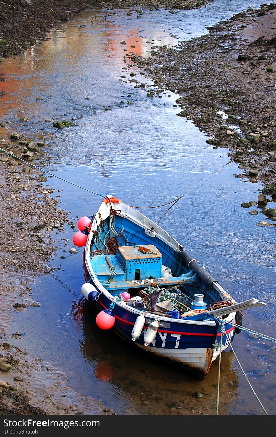 Small fishing boat moored in a creek. Small fishing boat moored in a creek