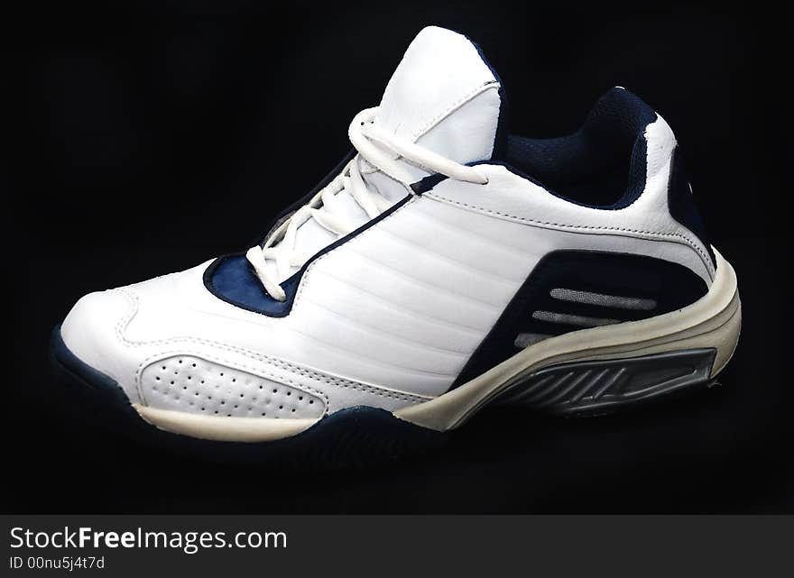 White sport shoes image on the black background