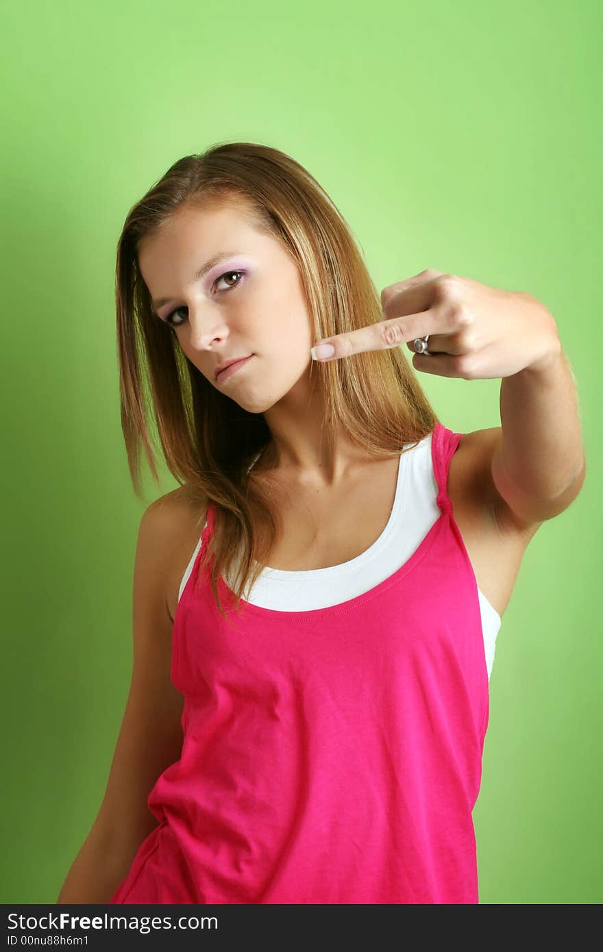 Portrait of a young unhappy woman is showing the finger. Portrait of a young unhappy woman is showing the finger