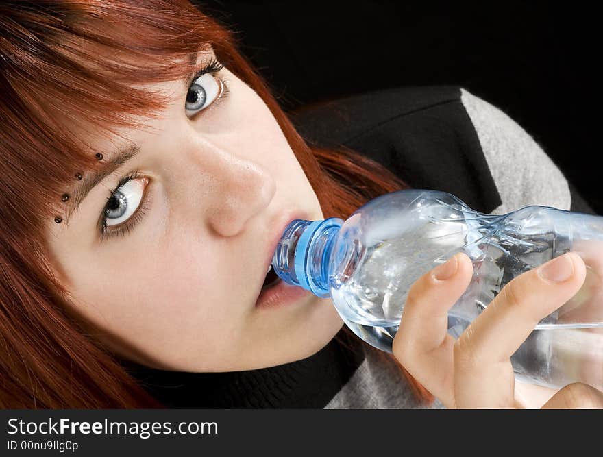 Seductive redhead girl looking at camera and drinking a bottle of water.

Studio shot. Seductive redhead girl looking at camera and drinking a bottle of water.

Studio shot.