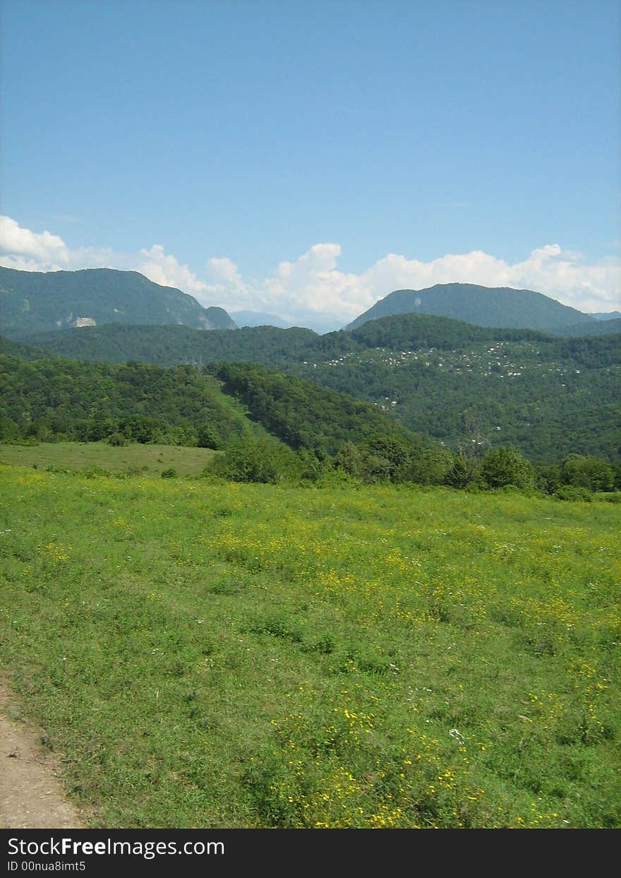 Hi mountain meadow on background blue sky. Hi mountain meadow on background blue sky