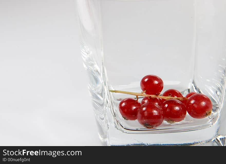 Red currant in a transparent glass